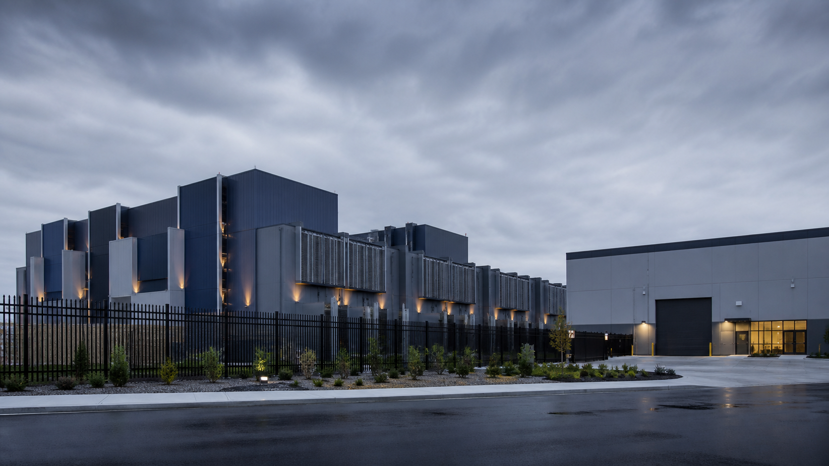 Modern manufacturing and warehouse facility behind a clean architectural perimeter
